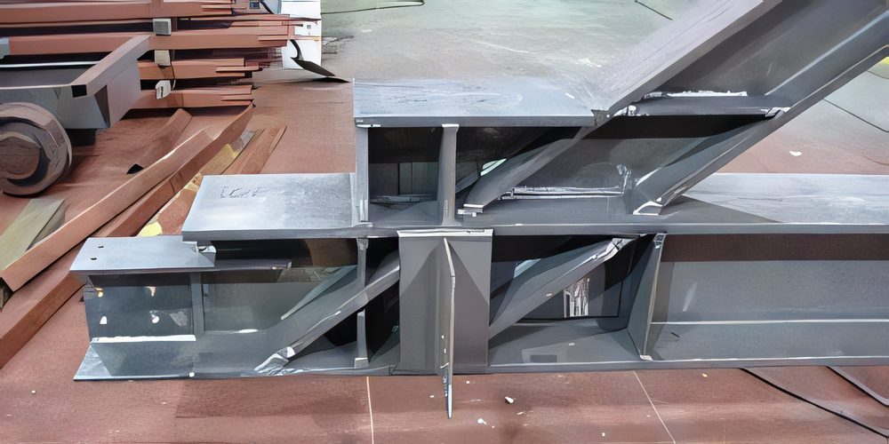 A welded beam connection with stiffener plates, laid out on the shop floor